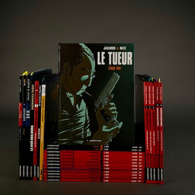 a stack of books with a picture of a man holding a gun