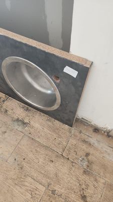 a sink in the middle of the floor in a room