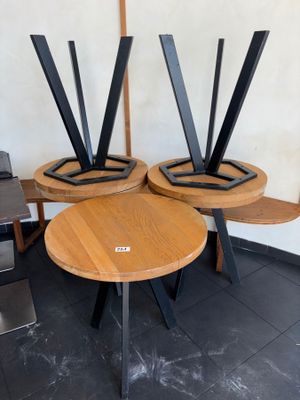three wooden tables with metal legs on them in a room