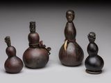 three small vases and a figurine of a man and a woman