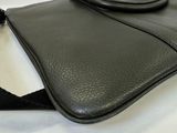 a black bag that is sitting on a white table