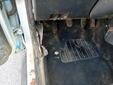 a dirty floor in a car with a metal grate