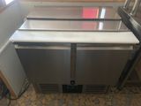 a stainless steel refridgerator in the corner of a kitchen