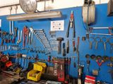 many tools hanging on the wall in the garage