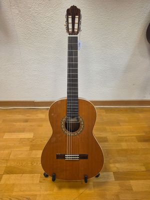 a guitar that is sitting on a stand on the floor