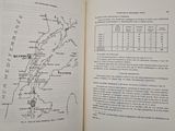 an open book with a map on it on a table