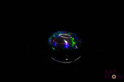 a close up of a glass object with a black background
