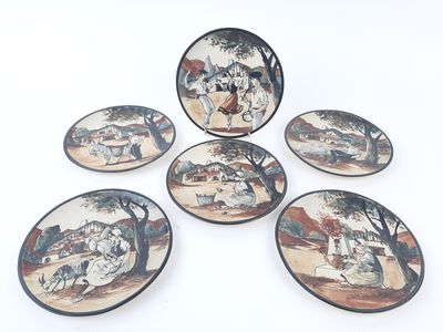 four plates with a picture of a man and a woman on them