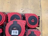 a lot of red and black fire hoses on the ground
