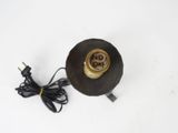 a black and gold light that is on a white surface