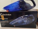 an image of a blue and black vacuum cleaner sitting on top of a box
