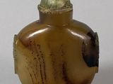 a picture of a brown and green vase on a table