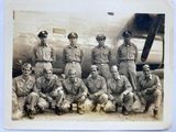 a black and white photo of a group of men posing for a picture