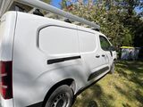a white van that is parked in the grass