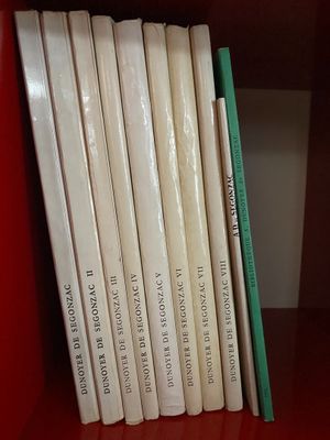 many books on a red book shelf on the shelf