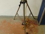 a tripod with a camera on a tripod in a room