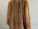 a close up of a fur coat on a mannequin stand