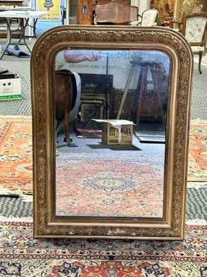 a mirror that is sitting on a rug on the floor