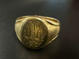 an image of a gold signet ring with a monogram on it