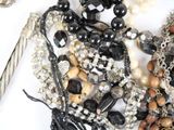 many different types of jewelry on a white surface