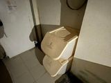 a toilet that is in the corner of a bathroom