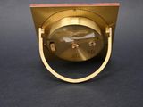 an image of a gold clock sitting on top of a black table