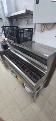 an image of a commercial kitchen with a conveyor belt