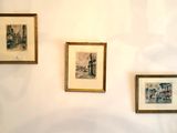 three framed pictures on the wall of a room
