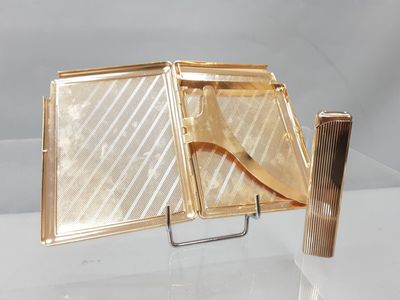 a gold case with a knife and fork inside of it