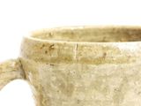 a close up of a cup on a white surface