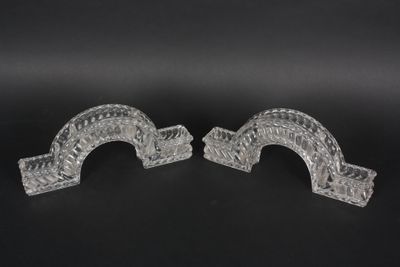 pair of clear glass bookends on a black background
