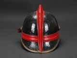 a close up of a helmet with a red ribbon on it