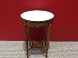 an image of a small table with a white top on a floor