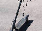 a scooter that is sitting on the ground in the parking lot