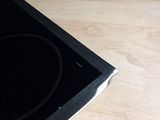 a black stove top with a black burner on top of it