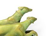 two statues of a dog and a cat on a table