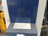 a picture of a blue and white trash can and a blue trash can