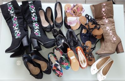 several pairs of women ' s shoes are lined up on a table