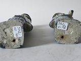 two small figurines that are sitting on a table