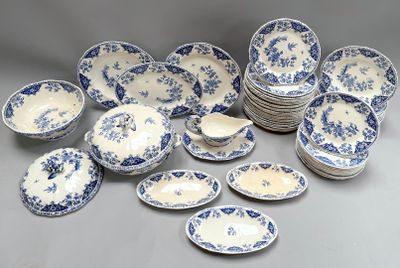 many blue and white plates and bowls on the table