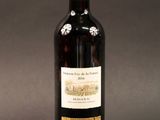 a bottle of wine that is sitting on a table
