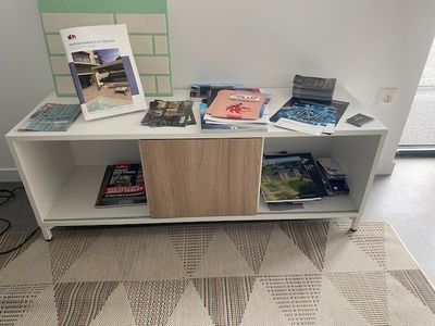a table with books and magazines on it in a room