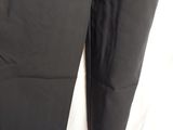 a pair of black pants sitting on top of a white sheet