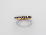 a yellow gold ring with blue sapphires