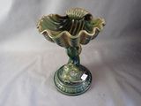 a green vase that is sitting on a white table