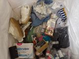 a plastic bag full of baby items on a bed