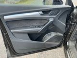 the door of a car with the driver ' s door open