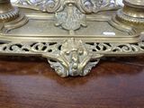 a gold candle holder on a wooden table