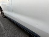 a white car that is parked on the side of the road