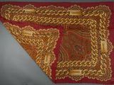 red and gold paisley scarf with gold chain and name tag